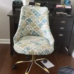 Espresso desk with a patterned desk chair.