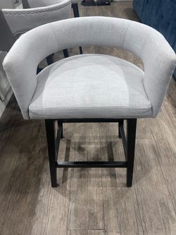 3 light grey upholstered counter stools