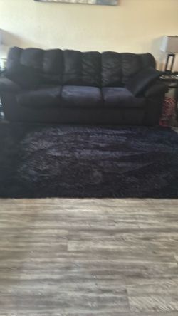 Large fluffy 6 x 9 black area rug in very good condition