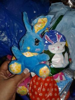 Plush bunny with bag of Easter candy eggs and toys