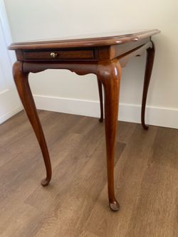 Queen Anne style mahogany tea table with cabriole legs and pull-out drawer.