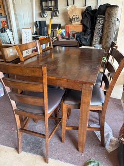 Counter-height dining table with collapsible leaf and 6 chairs