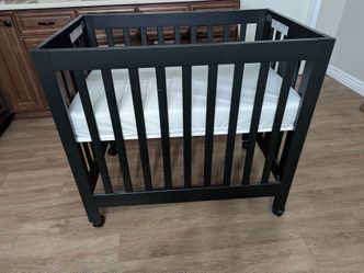 Black wooden mini/portacrib with mattress........$140 cash only