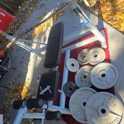 OLYMPIC WEIGHT BENCH  LEG EXTENSION  ADJUSTABLE INCLINE  AND  BAR HEIGHT.   7'  45LB BAR  WITH CLIPS    230LBs    2-45s. 2-35s. 2-25s  2-10s 
11525 S 