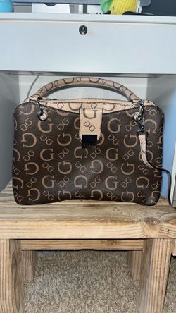 Woman’s brown guess purse
