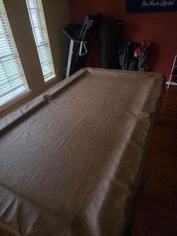 Pool table with pool ball and  sticks
