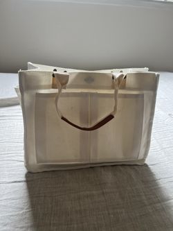 Cream canvas tote bag with straps and interior