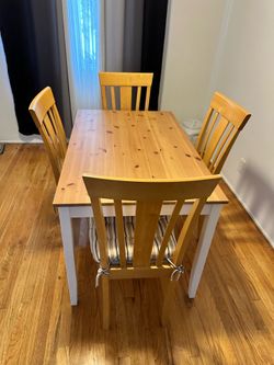 Dining room table with four padded chairs