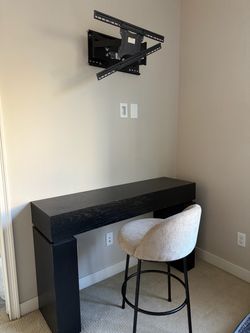 Desk, bar stool, and full-motion TV wall mount.”