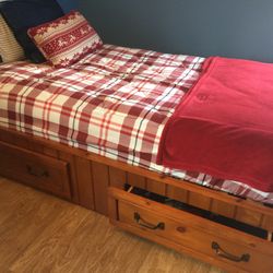 Pottery Barn solid pine twin beds with built-in drawers for storage.