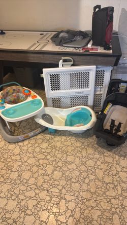 , baby bathtub a baby gate and a baby walker with wheels