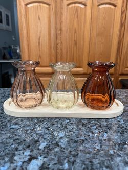 3 Piece Bud Vases Sitting on a piece of wood. They do not have to sit on the wood. See pictures. Size approximately 3 1/2 inches tall. Brand new ne