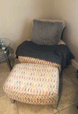 Chair with ottoman and large throw pillow