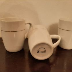 3 white cups with silver trim. Emerald brand.
$1. Each