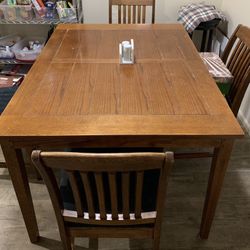 Solid oak table with 6 chairs and one leaf good elbow room.