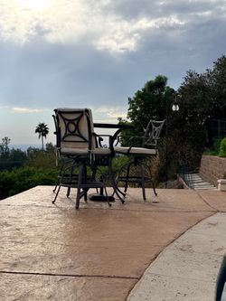 Rod iron table and three chairs