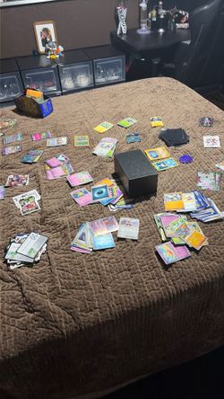 Lots of Pokémon cards and holders and some other sports cards