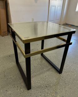 End/side table, square ribbed/fluted glass top and a black and gold metal frame