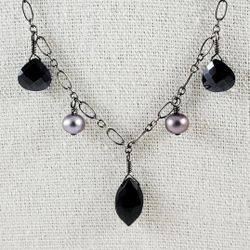 Susan Rifkin Artisanal sterling silver necklace featuring black glass accents.
