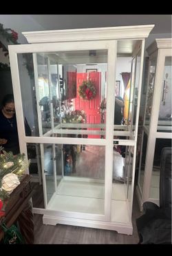 2 Howard Miller glass cabinets