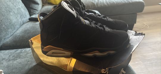 Gold and black Jordan 6s