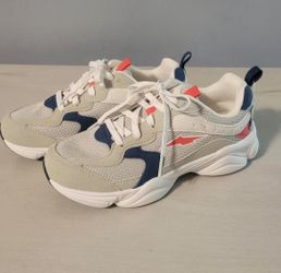 White sneakers with navy blue and coral orange accents