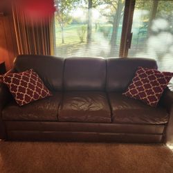 Leather sleeper sofa and two arm chairs with build in foot rest