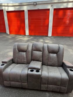 Gray Faux Leather Reclining Theater Sofa and Matching Reclining Loveseat.