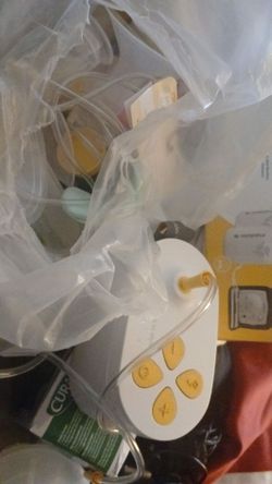 two breast pumps and breast feeding cover