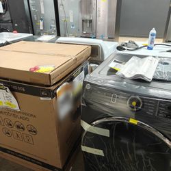 GE frontload washer and dryer set in dark