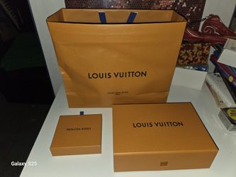 Empty large orange Louis Vuitton shopping bag and two orange Louis Vuitton boxes. 