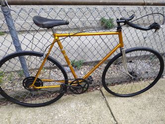 Raleigh metallic orange single speed road bike w bullhorn and freewheel