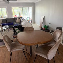 Dining table with four chairs and a leaf