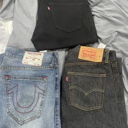 black and charcoal levi 501 and blue true religion jeans