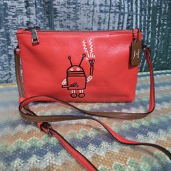 Coach x Keith Haring Lyla crossbody bag in orange pebbled leather featuring a robot design.  # Y