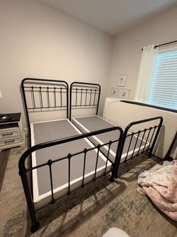 2 black metal twin beds