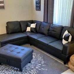 Black  leather sectional couch and ottoman