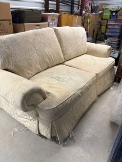 Beige patterned sofa, chair, and ottoman set