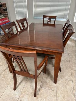 8piece Wooden Table with top glass and chairs