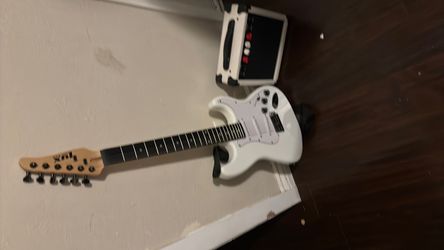 White Electric Guitar with Small Amplifier