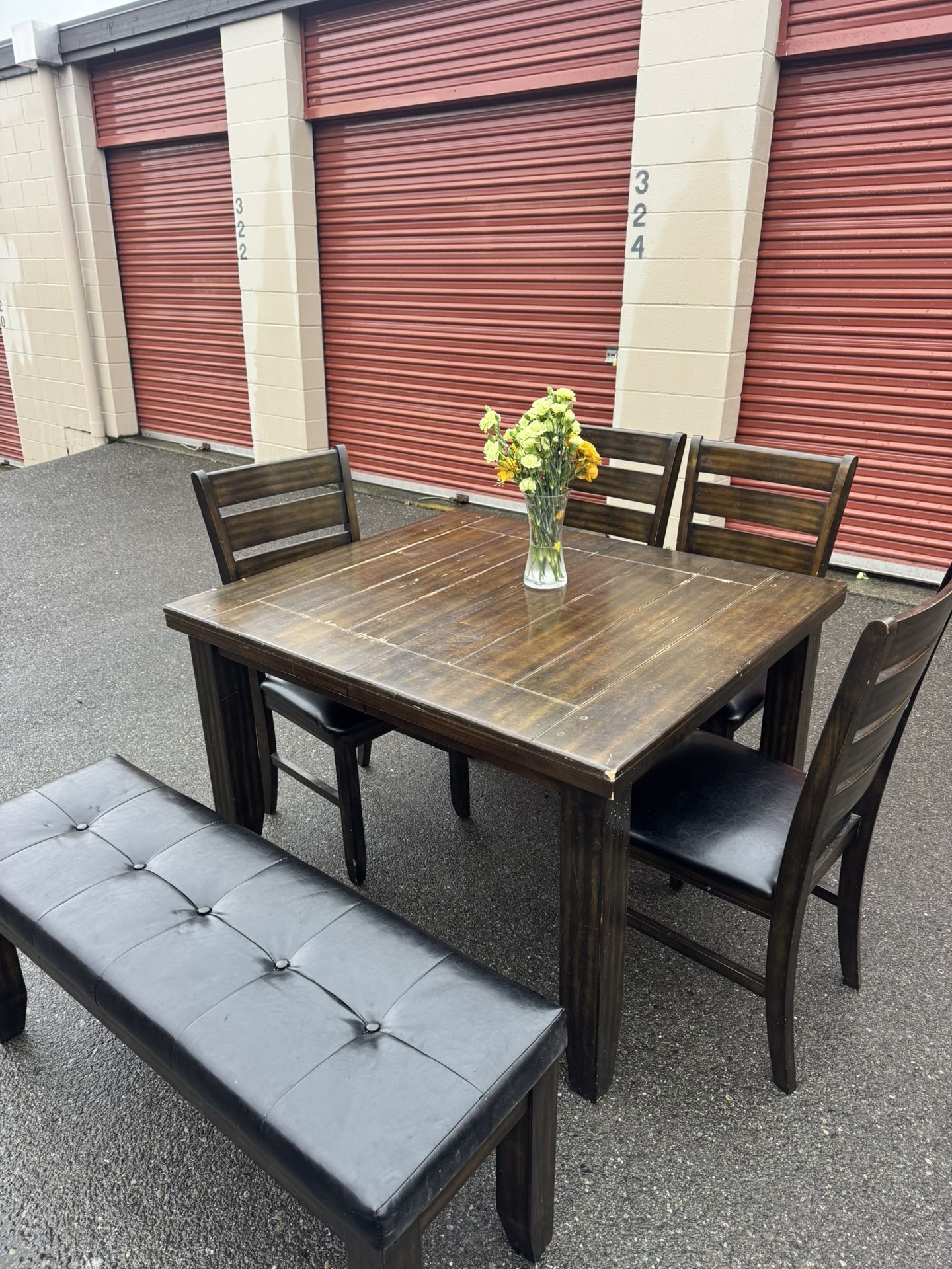 Wooden table and four chairs and a bench