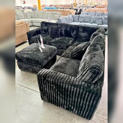 Black Jumbo corduroy sectional sofa with ottoman