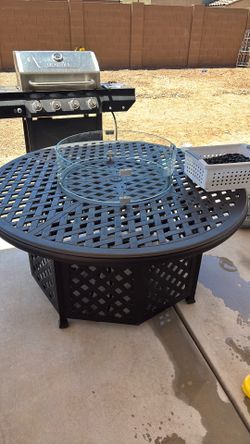 Barbecue pit basically new with rocks and propane tank