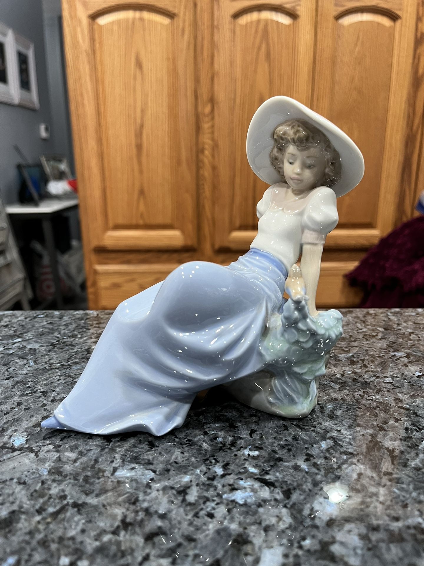 LLADRO (NAO) Figurine # 1042 Girl Listening To Songs Of Birds. Preowned Excellent Condition. The lighting is bad in the picture there are no white s