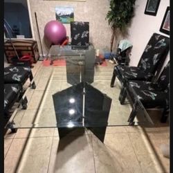 Glass dining room table with 6 chairs. Comes with table protector. Excellent condition.