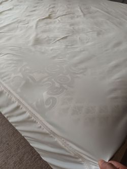White Mattress with Zippered Cover and wooden bed frame