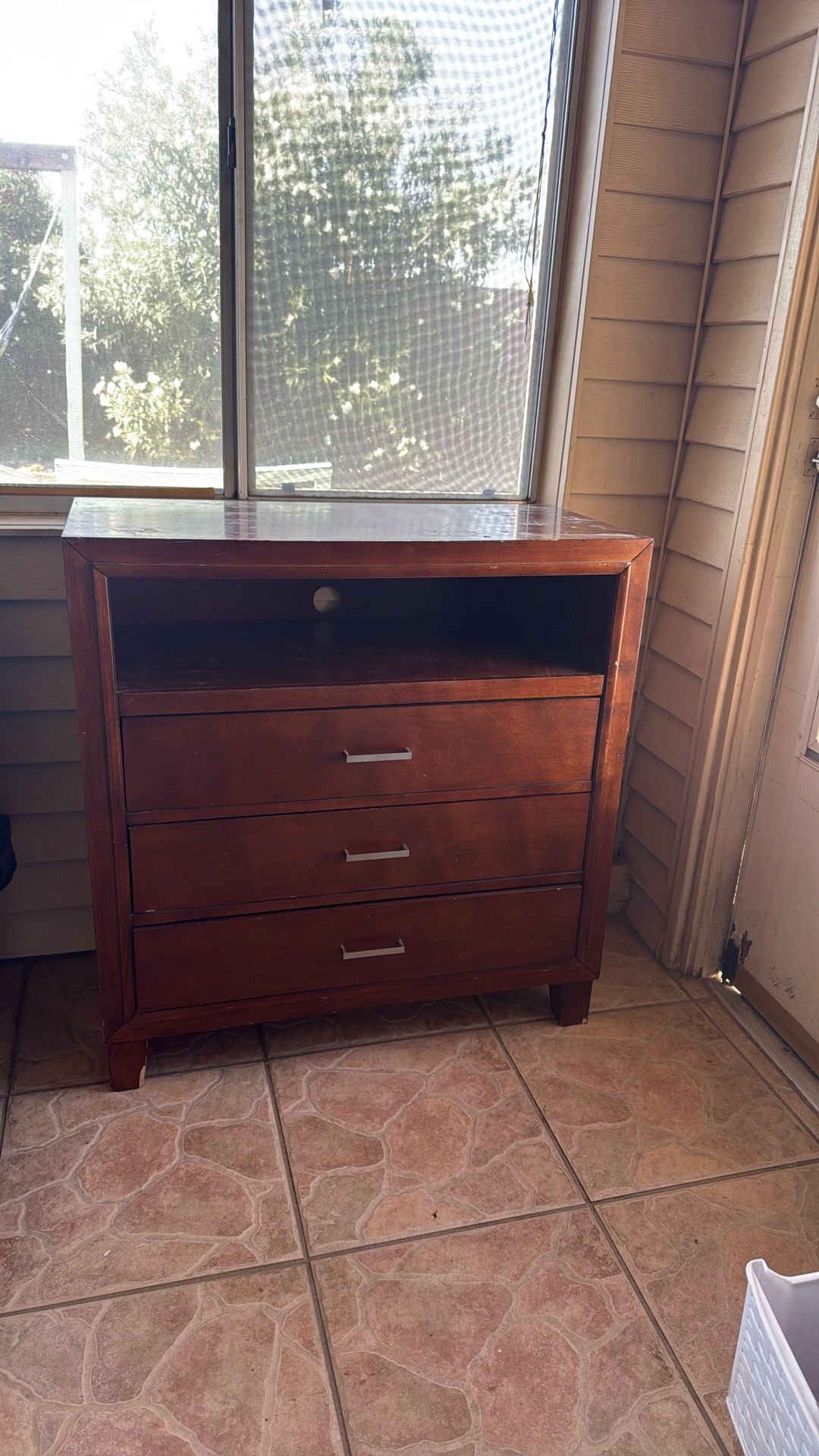 Brown dresser with open cabinet