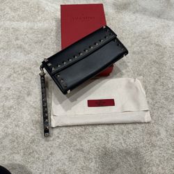 Valentino Garavani Rockstud leather wallet with a removable chain strap and platinum-finish studs.   Includes original dust bag. Box a