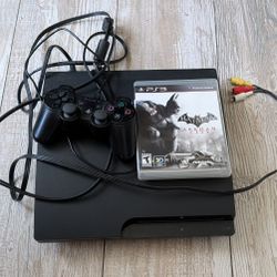 PS3 with controller and batman game
