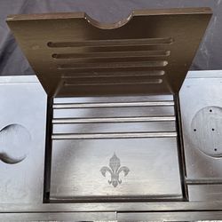 This is a black bamboo bathtub caddy tray with a book/tablet holder and a fleur-de-lis design